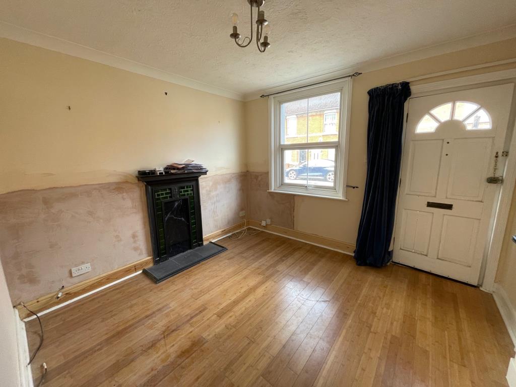 Lot: 43 - THREE-BEDROOM SEMI-DETACHED HOUSE FOR IMPROVEMENT - Living Room with Fireplace and new plaster following damp work